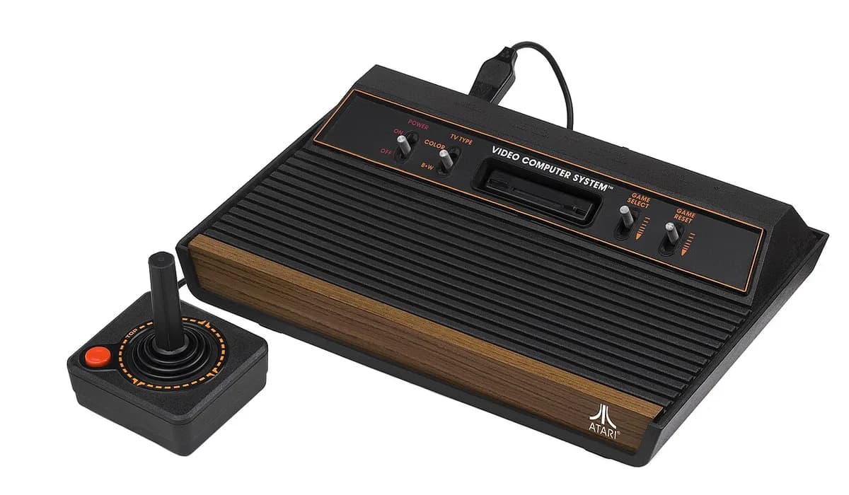 A wood-grain Atari 2600 console with a joystick